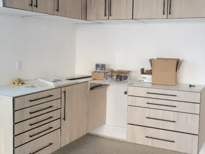 Custom garage cabinets with countertop workspace and drawers westlake project