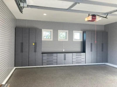Signature Series pewter garage cabinets with black bar handles and Graphite Black countertops installed in Frisco, TX