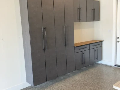 Signature Series pewter garage cabinets with black bar handles and Graphite Black countertops