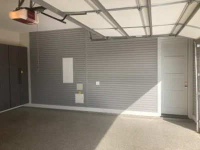 garage storage installation showing grey PVC slatwall and overhead storage racks Frisco TX
