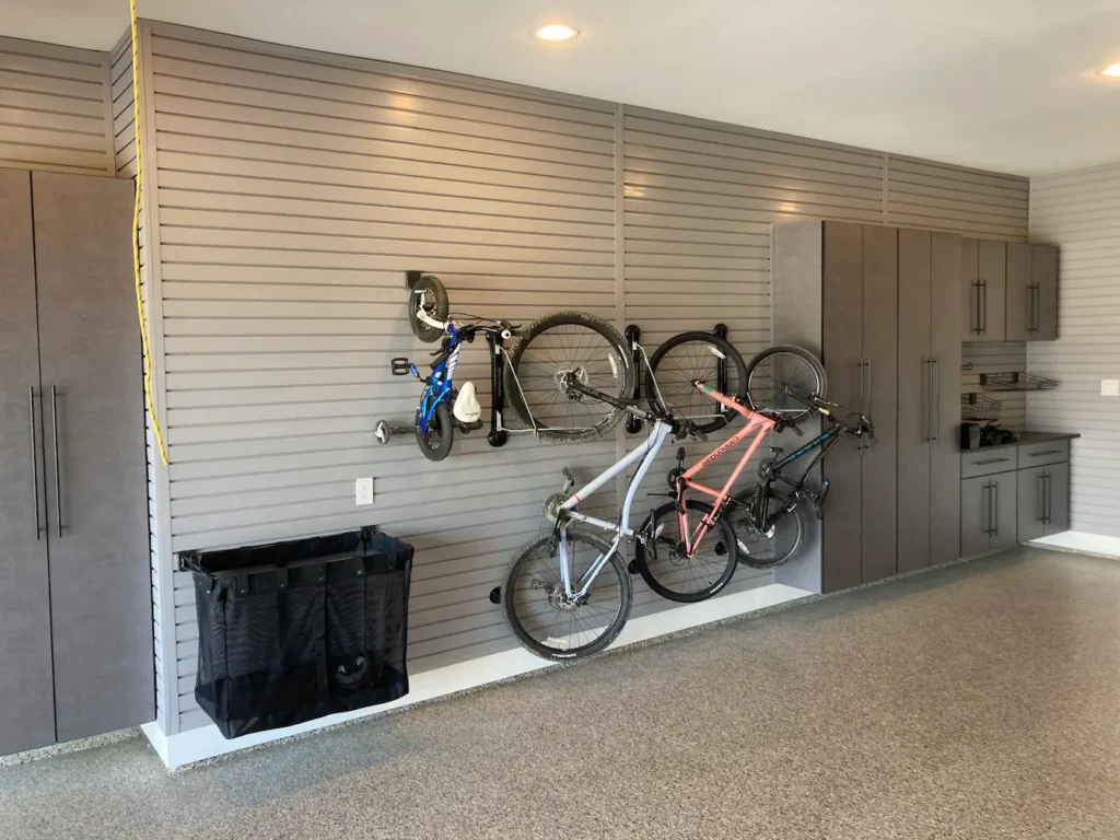 bikes mounted vertically on a gray slatwall storage system